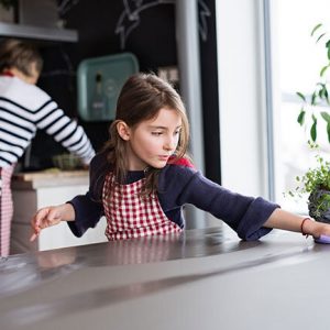 Girl Cleaning Kitchen Counter - Greener, Cleaner Lifestyle